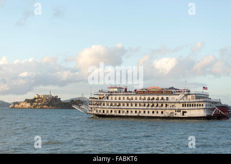 The historical San Francisco Belle paddlewheel boat in San Francisco Bay, California, USA approaching Alcatraz Island Stock Photo