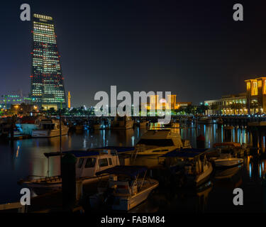 Boats and Souk Sharq at night Stock Photo