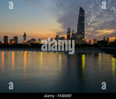 Kuwait City skyline at sunset, featuring Al-Hamra Stock Photo