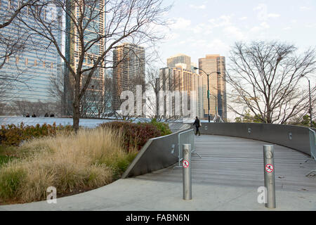 BP Pedestrian Bridge linking Maggie Daley Park with Millennium Park in Chicago, Illinois, USA with city skyline in the background Stock Photo