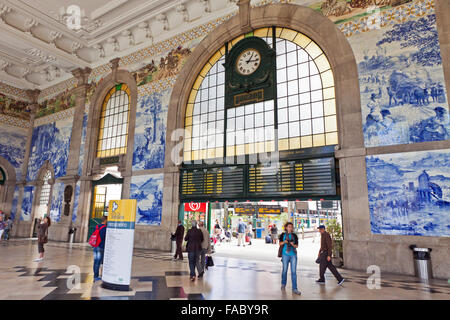 PORTO, PORTUGAL - JUNE 20, 2013: Painted ceramic tileworks (Azulejos) on the walls of Main hall of Sao Bento Railway Station in Porto. The building of station is a popular tourist attraction of Europe Stock Photo