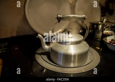 A kettle boils on an aga Stock Photo