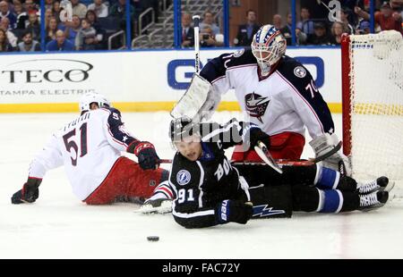 Tampa, Florida, USA. 26th Dec, 2015. DOUGLAS R. CLIFFORD | Times.Tampa Bay Lightning center Steven Stamkos (91) slides through the crease after colliding with Columbus Blue Jackets defenseman Fedor Tyutin (51) while challenging Columbus Blue Jackets goalie Joonas Korpisalo (70) during the first period of Saturday's (12/26/15) game at Amalie Arena in Tampa. Credit:  Douglas R. Clifford/Tampa Bay Times/ZUMA Wire/Alamy Live News Stock Photo