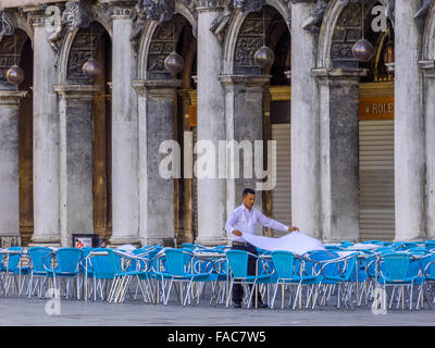 Setting up tables of outdoor restaurant in San Marco square in Venice, Italy Stock Photo