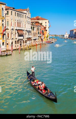 Tourists in gondola exploring Grand Canal, Venice, Veneto, Italy, UNESCO Stock Photo
