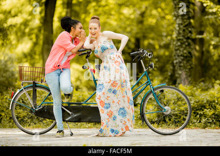 Young women posing by the bicycle Stock Photo