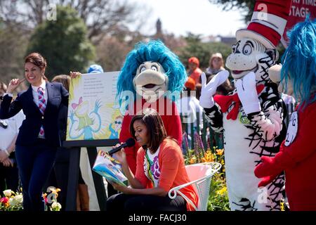 US First Lady Michelle Obama reads Dr. Seuss's 'Oh the Things You Can Do That are Good for You!' to children gathered on the South Lawn of the White House during the annual Easter egg roll April 6, 2015 in Washington, DC. Stock Photo