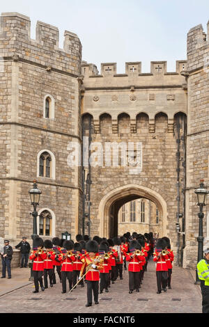 Changing the Guard - a military band emerge from the Henry VIII Gate at Windsor Castle, Berkshire, England, UK Stock Photo