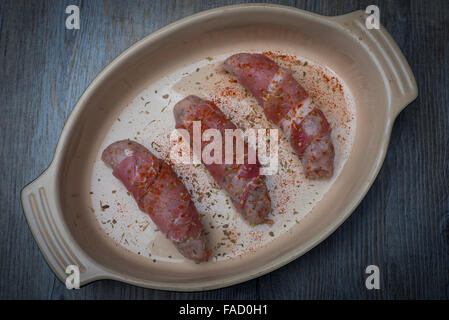 prepared 'pigs in blankets' in a dish ready for cooking