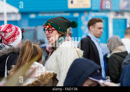 Woman in bobble hat and novelty spectacles at a Christmas charity event Stock Photo