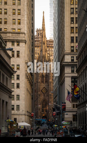 Trinity Church, built in 1846, perfectly framed between two modern towers on Broadway and Wall Street in New York City Stock Photo