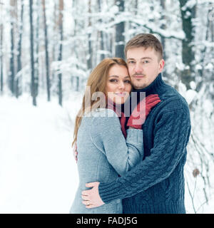 Portrait of happy couple in winter park Stock Photo