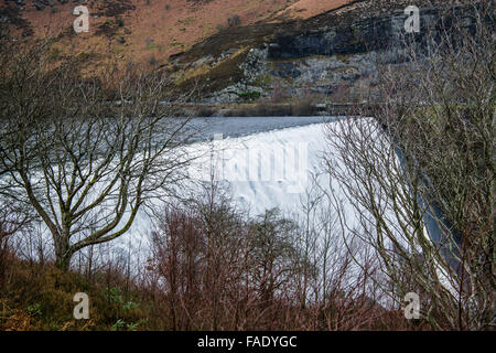 Elan Valley, near Rhayader, Powys Wales UK. 28th December, 2015.    After weeks of heavy rain the waters overtop the Caban Coch dam in the Elan Valley, west of Rhayader Powys Mid Wales.    Caban Coch is the lowest link in a chain of 6 dams and  reservoirs built a hundred years ago feeding into a  73 mile gravity driven aqueduct  to supply clean water to the city of   Birmingham    Credit:  keith morris/Alamy Live News Stock Photo