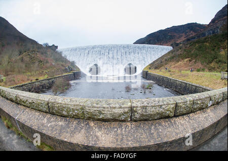 Elan Valley, near Rhayader, Powys Wales UK. 28th December, 2015.    After weeks of heavy rain the waters overtop the Caban Coch dam in the Elan Valley, west of Rhayader Powys Mid Wales.    Caban Coch is the lowest link in a chain of 6 dams and  reservoirs built a hundred years ago feeding into a  73 mile gravity driven aqueduct  to supply clean water to the city of   Birmingham    Credit:  keith morris/Alamy Live News Stock Photo