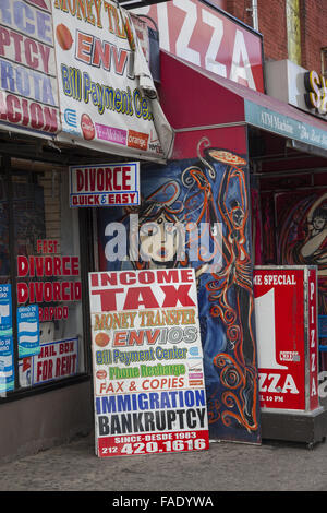 Storefront advertising everything from quick divorce to income tax and bankrupcy help on Essex Street on the Lower East Side, Manhattan, NYC. Stock Photo