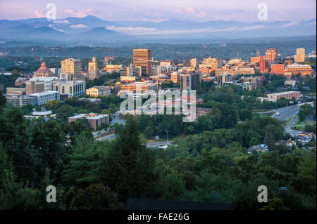 Sunrise lights the buildings of downtown Asheville, North Carolina, nestled in the Blue Ridge Mountains. (USA) Stock Photo