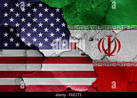 flags of USA and Iran painted on cracked wall Stock Photo