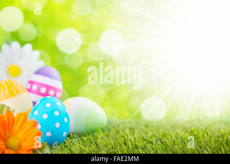 A collection of colourful hand-painted Easter eggs lying in the grass. Stock Photo