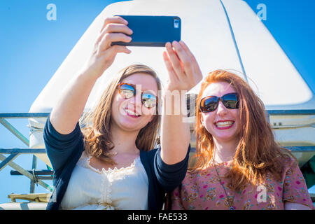 Girls taking a selfie with iPhone Stock Photo