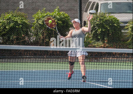 Female tennis player hitting a forehand volley Stock Photo