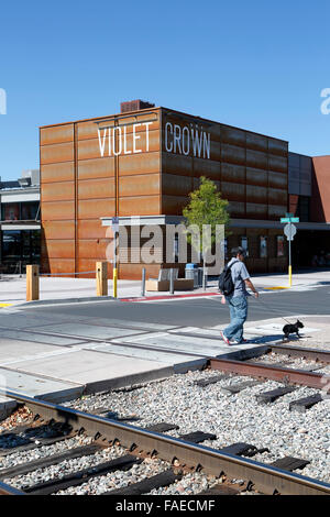 Person walking dog in front of Violet Crown Cinema, Railyard District, Santa Fe, New Mexico USA Stock Photo