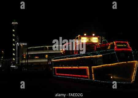 Night view Pleasure Beach Casino, illuminated HMS Blackpool frigate tram, South Shore Turning Circle, Blackpool Illuminations Stock Photo