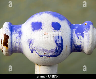 Smiling face on an iron face Stock Photo