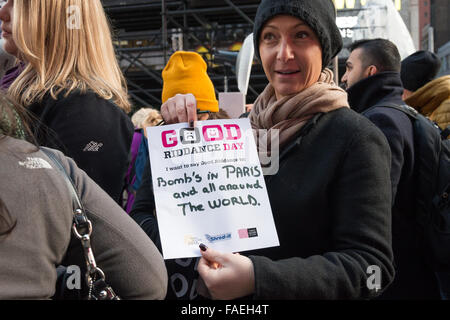 New York, USA. 28th Dec, 2015. A participant from France displays the piece of paper she will shred in hopes of a better new year: a piece of paper referencing the Paris bombings and terrorist attacks worldwide. In advance of the New Year, Times Square Alliance hosted the ninth rendition of its annual 'Good Riddance Day,' where the public is invited to symbolically shred letters, photos, or written messages conveying unpleasant memories from 2015. Credit:  PACIFIC PRESS/Alamy Live News Stock Photo