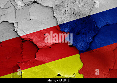 flags of North Ossetia-Alania and Russia painted on cracked wall Stock Photo