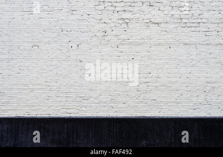 White brick wall and black skirting texture Stock Photo