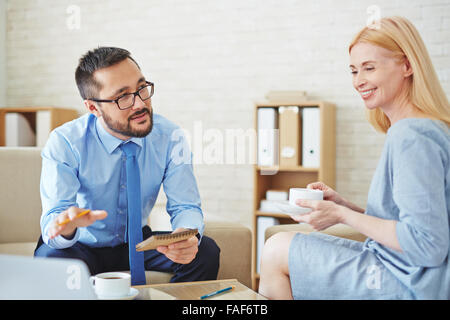 Businessman and businesswoman having a meeting during coffee break Stock Photo