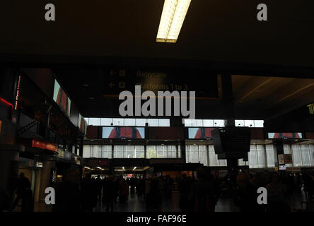 Interior view, towards entrance doors, silhouettes of people, east side of Main Concourse, Euston Station, London, UK Stock Photo