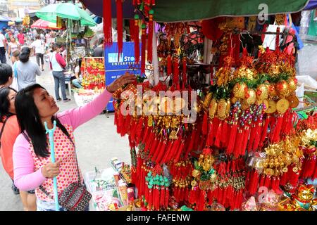 Manila, Philippines. 29th Dec, 2015. A vendor arranged her lucky charm in the street of Manila as part of the celebration to welcome the 2016 new year, this traditions was influences by the Chinese tradition to the Filipino culture to ensure that the new year being welcomed is a prosperous one. © Gregorio B. Dantes Jr./Pacific Press/Alamy Live News Stock Photo