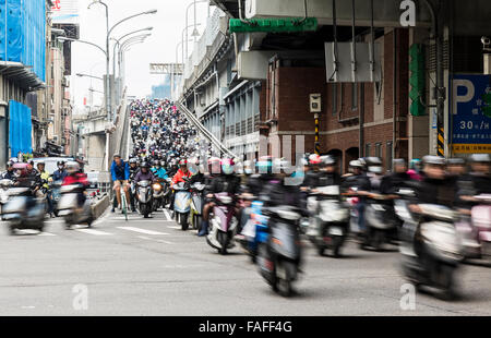 Taipei, Taiwan - December 2015 - Heavy rush hour scooter traffic on a busy Taiwanese road.. Stock Photo