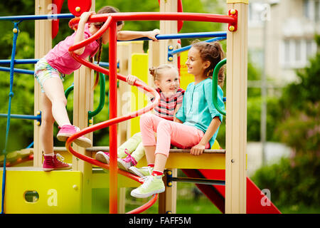 Three girls playing together on playground Stock Photo