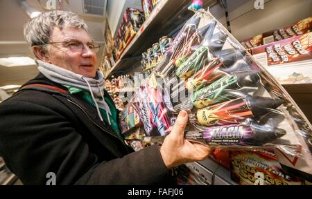 Hamburg, Germany. 29th Dec, 2015. A man chooses fireworks for New Year's Eve in a drugstore in Hamburg, Germany, 29 December 2015. The sale of fireworks started on the same day. Photo: MARKUS SCHOLZ/dpa/Alamy Live News
