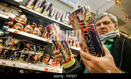 Hamburg, Germany. 29th Dec, 2015. A customers picks fireworks for New Year's Eve in a drugstore in Hamburg, Germany, 29 December 2015. The sale of fireworks started on the same day. Photo: MARKUS SCHOLZ/dpa/Alamy Live News