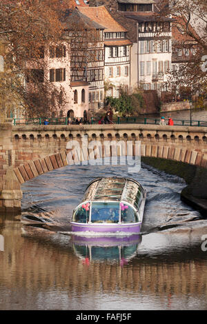 A tourist boat going under the covered bridges, Petite France, Strasbourg France Europe Stock Photo