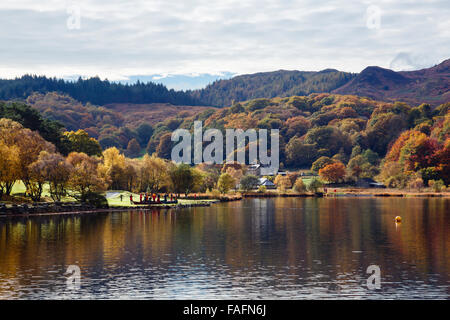 Llyn Geirionydd lake in Gwydyr Forest Park below Crimpiau with outdoor activities group on shore in autumn. Snowdonia National Park (Eryri) Wales UK Stock Photo