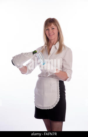 Waitress wearing white cotton gloves pouring sparkling wine from a green bottle Stock Photo