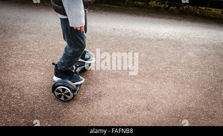 Person Riding a HoverBoard on a Public Footpath, They are now banned in all public places in the United Kingdom Stock Photo