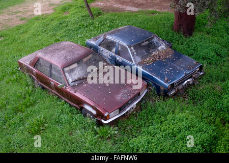 Overhead view of two abandoned old cars side by side Stock Photo