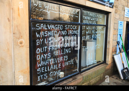Hebden Bridge, UK. 29th Dec, 2015. Defiant sign in the window of one of the shops devastated in the Boxing Day floods in Hebden Bridge Credit:  Graham Hardy/Alamy Live News Stock Photo