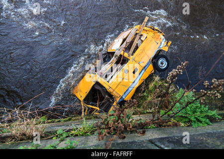 Hebden Bridge, UK. 29th Dec, 2015. A wrecked camper van still stuck under the bridge at Hebble End  in the Centre of Hebden Bridge following the Boxing Day floods. Credit:  Graham Hardy/Alamy Live News Stock Photo