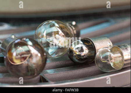 dead worn out rear light braking light for car silvered interior glass blown filament failed illegal MOT risk of not seen night Stock Photo