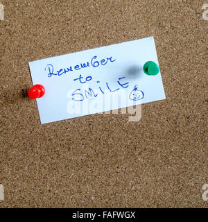 Remember to Smile on Paper Note on cork board Stock Photo