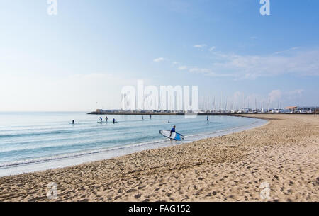 Winter beach with surfers and stand up paddlers near marina and on sandy Playa de Palma on December 13, 2015 in Balearic islands Stock Photo