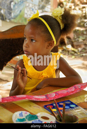 Little girl working on art project (painted seed pod), Pinar del Rio, Cuba Stock Photo