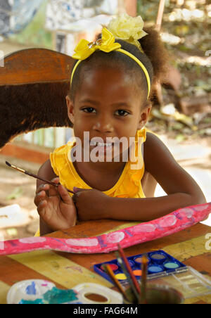 Little girl working on art project (painted seed pod), Pinar del Rio, Cuba Stock Photo