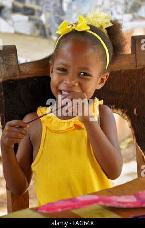 Little girl working on art project (painted seed pod), Pinar del Rio, Cuba Stock Photo